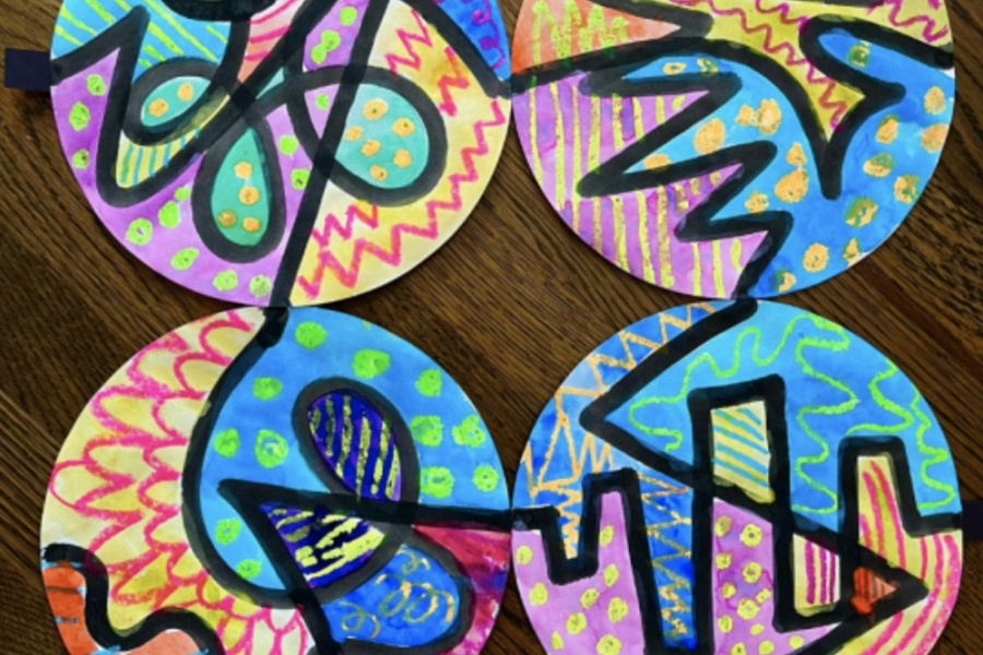 Colorful abstract art on circular paper, featuring vibrant patterns and designs.