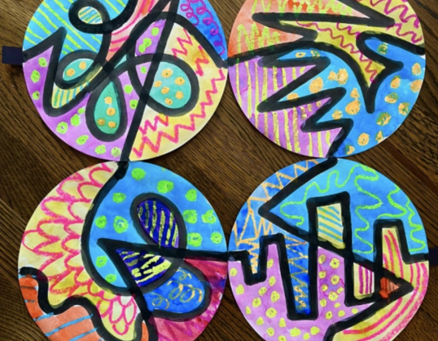 Colorful abstract art on circular paper, featuring vibrant patterns and designs.