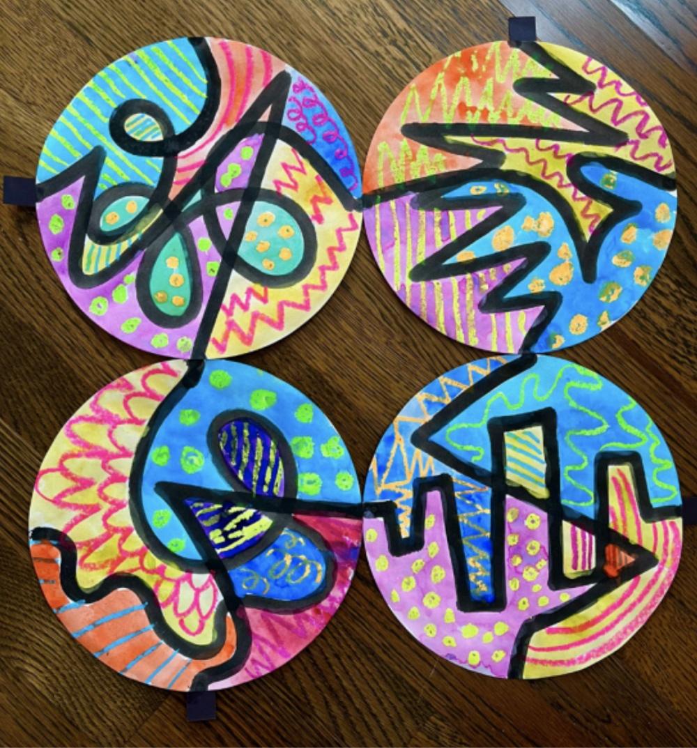 Colorful abstract art on circular paper, featuring vibrant patterns and designs.